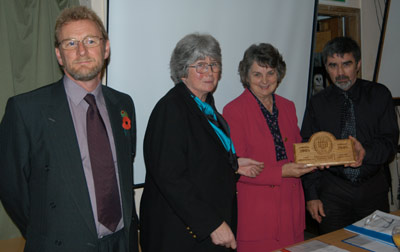 Rhiannon Scott and Wyn Jones of Llangadog Balchder Bro receiving their award from Cllr Mrs Margaret Morris, Chairman for the Brecon Beacons National Park Authority with Chris Gledhill, Chief Executive for the Brecon Beacons National Park Authority on the left